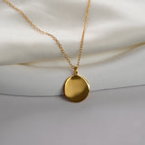 Gold disc pendant necklace