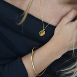 Gold disc pendant necklace